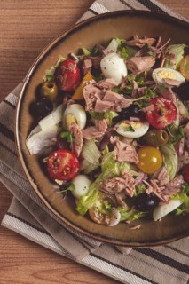 Salad with canned tuna, vegetable salad with quail eggs, lettuce, red onion, cherry tomatoes,