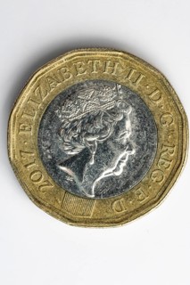 Close-up of the obverse of a British one pound coin, white background