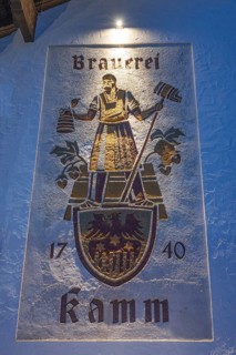 Evening lighting from the house sign of the Kammbräu inn, Zenting, Lower Bavaria, Germany