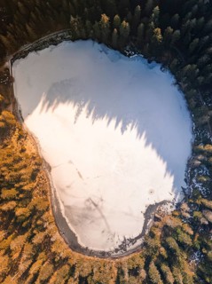 A frozen lake from above, surrounded by bare trees in winter, Glaswaldsee, Bad