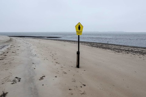 Nature reserve sign on the beach of Amrum, Schleswig-Holstein, Germany
