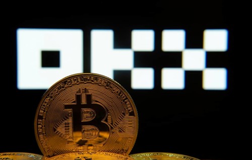 Dhaka, Bangladesh- 04 April 2025: Close-up of Bitcoin coins with the OKX logo visible on a screen
