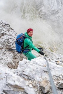 Hiker climbing on a steel cable, Carnic Main Ridge, Carnic High Trail, Carnic Alps, Carinthia,