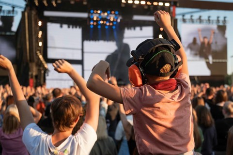 Applause of a boy with headphones during music concert