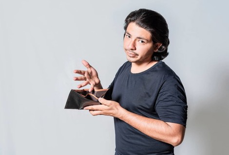 Young man with financial crisis holding wallet isolated. Sad man holding empty wallet. Unhappy man