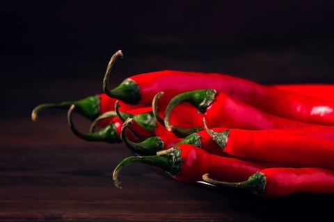 Bunch of red hot chili pepper, close-up, on a dark background, selective focus, no people, concept,