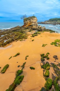 Monument to Neptune Child (Ramon Muriedas) on Camello beach in Santander, Cantabria, Spain