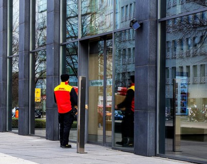DHL parcel carrier delivering parcels, Berlin, Germany