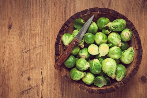 Fresh Brussels sprouts, raw, top view, on a wooden table, no people