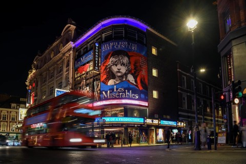 Red double-decker bus outside the Sondheim Theatre, Les Misérables, Musical, West End, London,