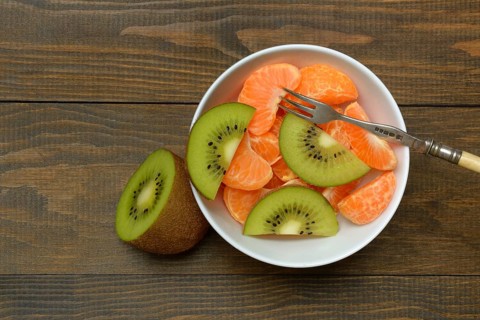 Clementine pieces and kiwi slices in peel