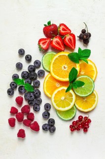 Mix of fruits and berries, set, assortment, sliced citrus fruits, raspberries, blueberries, mint