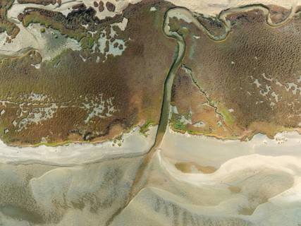 Marshes and streams at low tide in the Walvis Bay Lagoon. Aerial view. Drone shot. Namibia