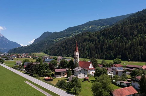 Drone shot, view of village with parish church, Schönwies, Oberinntal, Tyrol, Austria