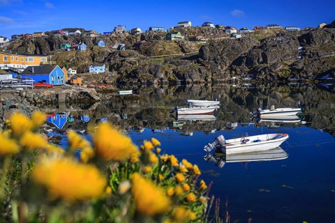 Inuit settlement, village and boats by the sea off Bergen, sunny, Sisimiut, West Greenland,