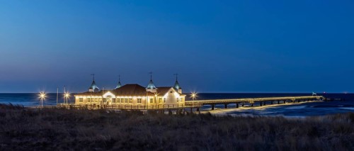 Restaurant on Ahlbeck Pier, Seebrücke Ahlbeck illuminated at dusk in the Baltic Sea on Usedom