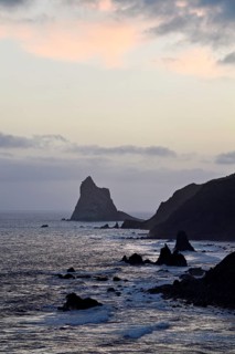 Beach of Playa de Benijo at high tide with the rock Roques de Anaga in the light of the rising sun,