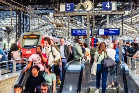 Cologne Central Station. Stairs to the platforms. Travellers waiting for their train on the