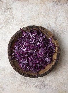 Red cabbage, sliced, in a wooden salad bowl, top view, no people
