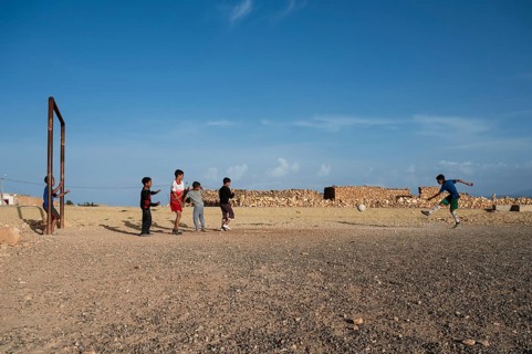 Taouloukoult, MOROCCO - OCTOBER 6, 2024: young boys spend the afternoon playing amateur football on