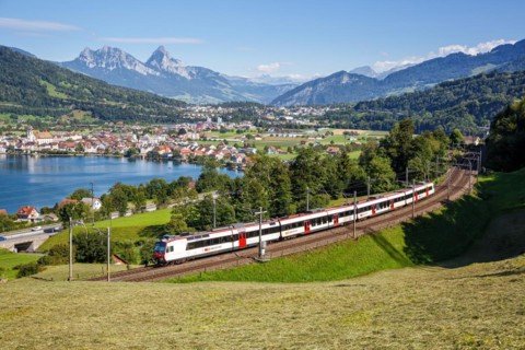 Railway passenger train of the Swiss Federal Railways SBB at the mountain Großer Mythen at Lake Zug
