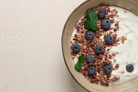 Yogurt with chocolate muesli, with berries, blueberries, breakfast, close-up, fork on top, no