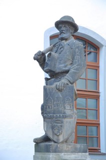 Miner figure with city coat of arms, symbol for historical mining, worker, miner, sculpture,