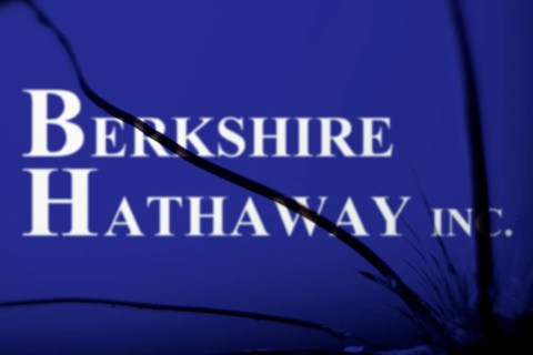 Berkshire Hathaway inc logo is visible on the broken glass. Berkshire Hathaway Inc is an American