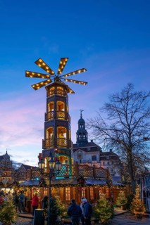 Large Christmas pyramid at the Christmas market at dusk, behind the historic town hall, Lüneburg,