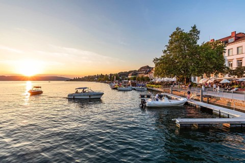 Motorboats and restaurants on the lakeside promenade in Überlingen, Lake Constance,