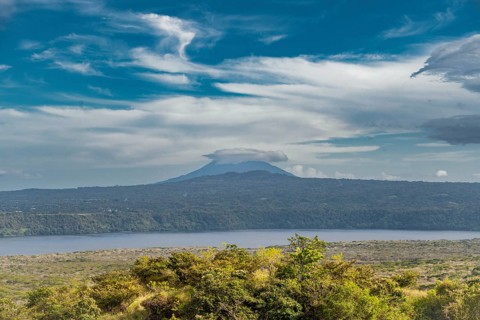 Landscape of a volcano with a blue sky surrounded by green vegetation, Nicaragua. View of a