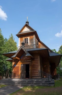 Traditional wooden church surrounded by trees under a blue sky, monastery of St Martha and St Mary,