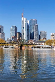 Frankfurt skyline skyscrapers with banks on the river Main with excursion boats and Eiserner Steg