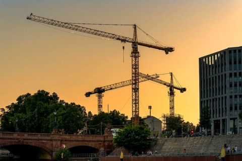 Evening sun, construction cranes around Berlin Central Station, Berlin, Germany