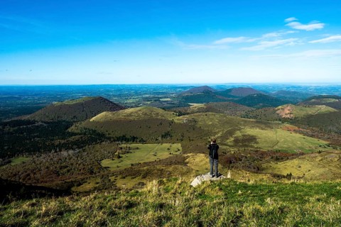 Tourist photographing in Regional natural park of Auvergne Volcanoes, Unesco World heritage, Puy de