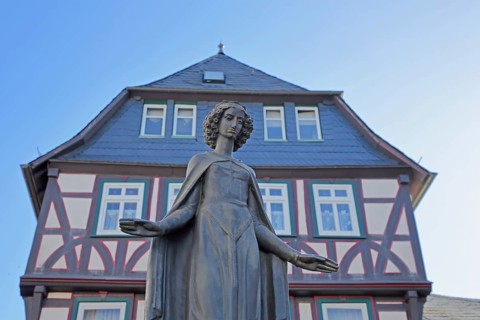 Sculpture of Saint Barbara of Nicomedia, martyr, female figure, outstretched arms with gesture,
