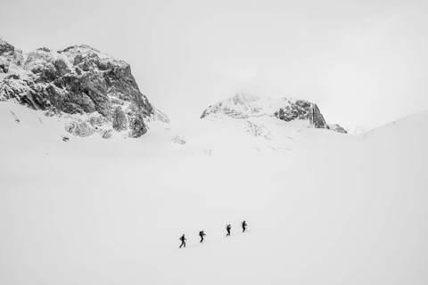Group of lonely ski tourers in a snowy mountain landscape, Bernese Alps, Switzerland