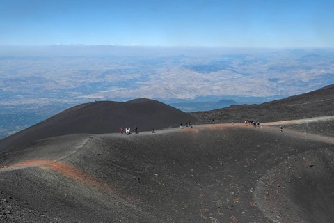 Hikers in the crater landscape of the volcano Etna, summit region, province of Catania, Sicily,