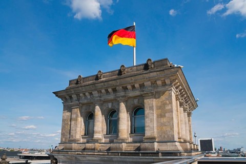 German Reichstag building with waving flag in front of blue sky, Reichstag building, German