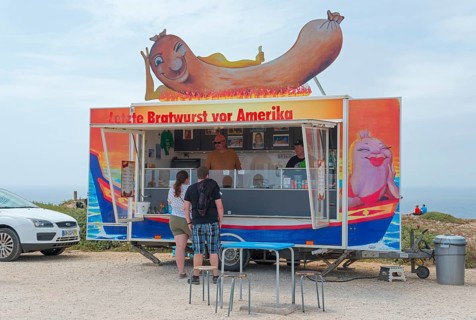 Humorous food truck selling sausages on the beach, Last sausage in front of America, Cabo de São