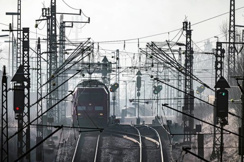 Deutsche Bahn AG tracks backlit with RegionalExpress. Overhead line, signals and infrastructure.