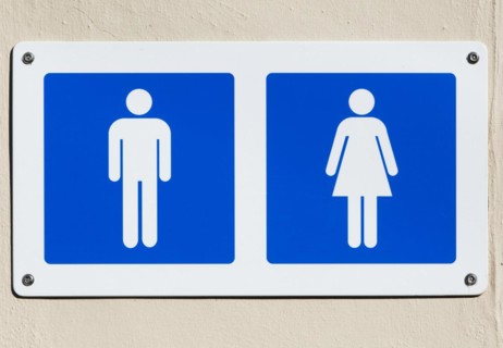 Cut out white male and female figures on blue background, public toilets sign UK