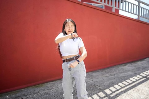 K-pop female asian young dancer performing in the street