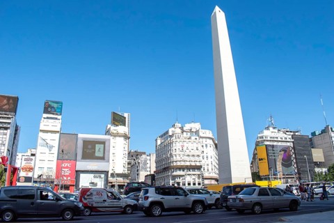Rush hour on Avenida 9 de Julio with the obelisk, the symbol of Buenos Aires, Argentina