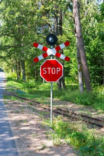 A red stop sign at a railway crossing in the forest, Suwalki, Podlaskie, Poland