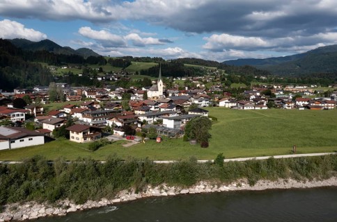 Drone shot, view of the village with parish church, Kössen, Leukental, Tyrol, Austria