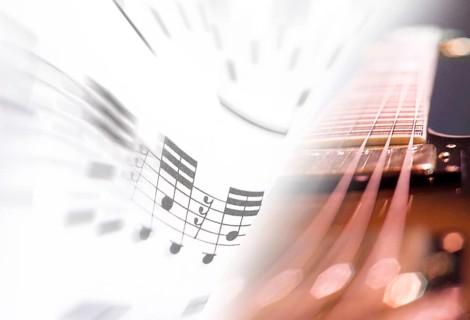 Detailed view of a guitar, sheet music, composing