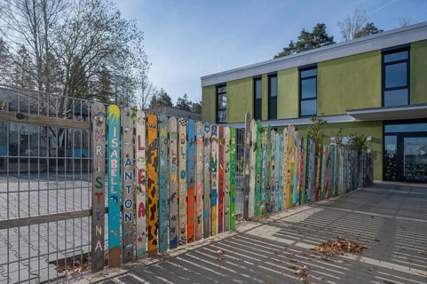 Colourfully painted fence, entrance to kindergarten, Wendelstein, Middle Franconia, Bavaria,