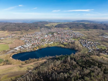 Aerial view of the municipality of Steißlingen with the natural bathing lake Steißlinger See,