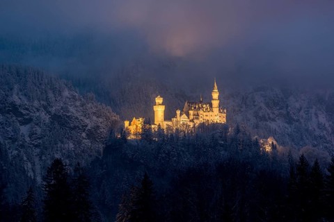 Mystical castle in the winter fog, romantically illuminated, Neuschwanstein, Schwangau, Ostallgäu,